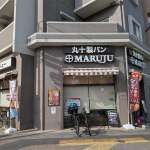 ▲十字の紋章が映える「丸十製パン」。駅近活気あふれる店構え